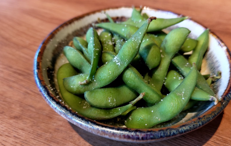 Boiled edamame, young soy beans in pod.